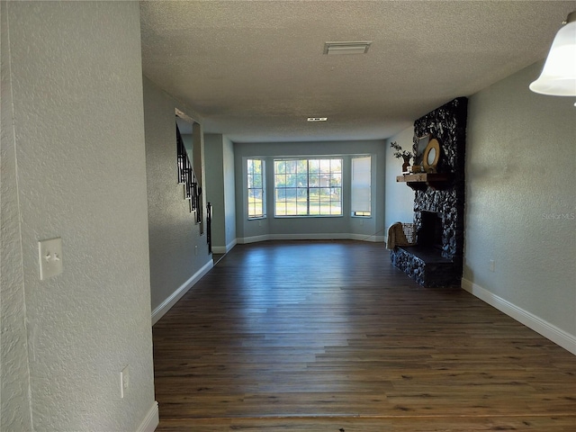 corridor featuring dark wood-type flooring and a textured ceiling