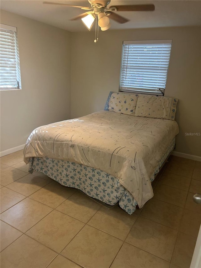 bedroom with ceiling fan and light tile patterned flooring