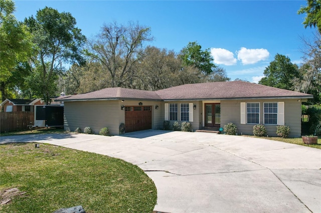 ranch-style home featuring a front yard and a garage