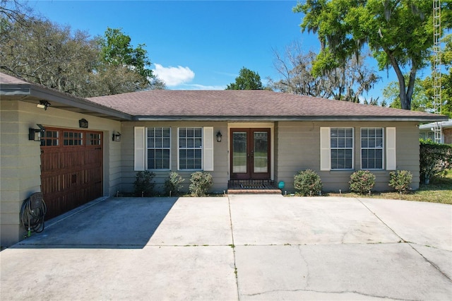 ranch-style house with french doors and a garage