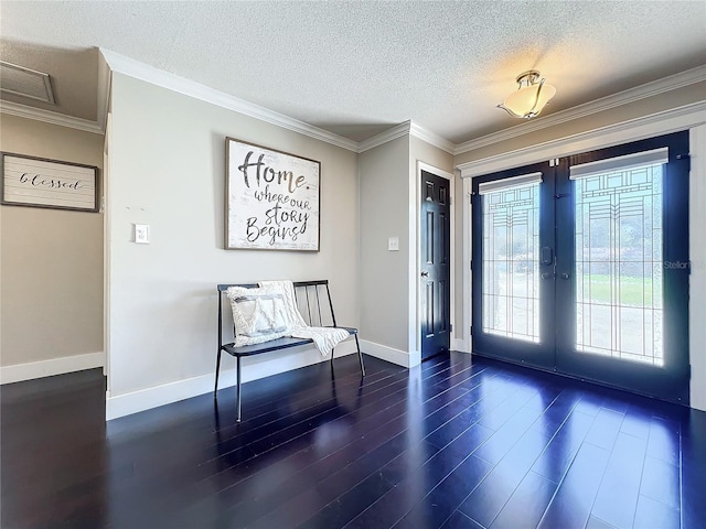 entryway with french doors, dark hardwood / wood-style flooring, a textured ceiling, and ornamental molding