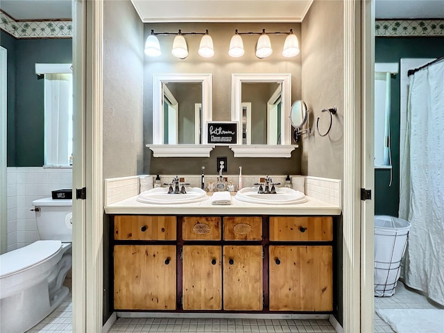 bathroom with tile patterned flooring, vanity, toilet, and ornamental molding