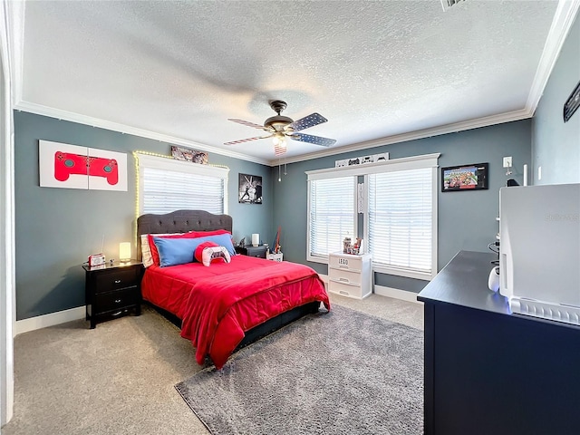 carpeted bedroom with a textured ceiling, ceiling fan, and ornamental molding