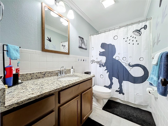 bathroom featuring tile patterned floors, vanity, tile walls, and ornamental molding