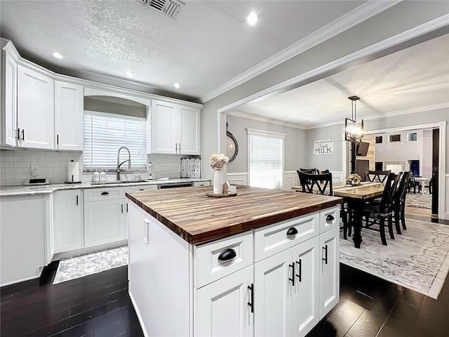 kitchen featuring a center island, dark hardwood / wood-style floors, plenty of natural light, and sink