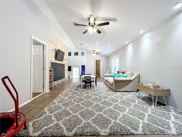 tiled living room with ceiling fan, a fireplace, and lofted ceiling