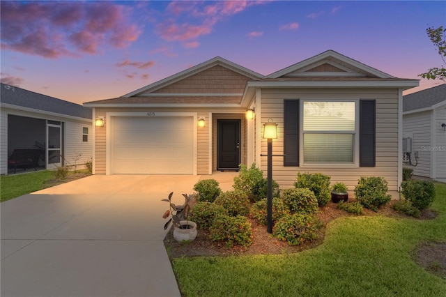 ranch-style home with a yard and a garage