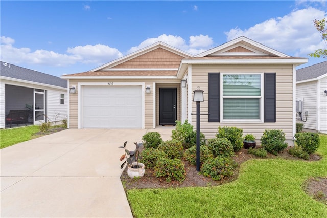 single story home featuring a garage and a front lawn