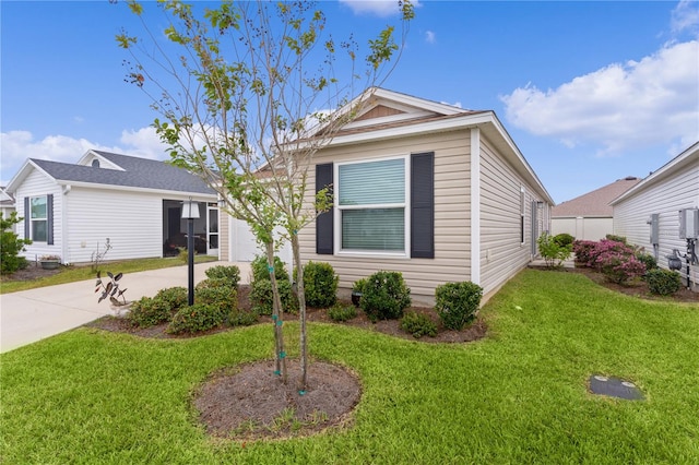 view of front of home featuring a garage and a front lawn