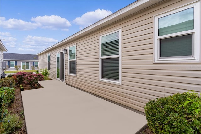 view of side of home with a patio area