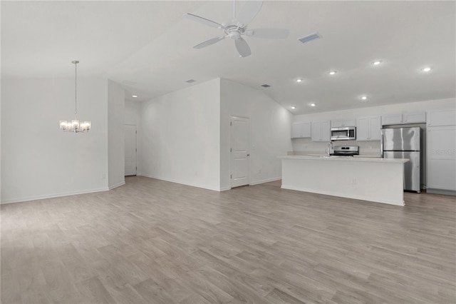 unfurnished living room featuring ceiling fan with notable chandelier, light hardwood / wood-style floors, and lofted ceiling