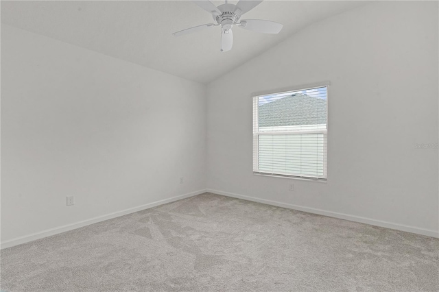 unfurnished room featuring light colored carpet, vaulted ceiling, and ceiling fan