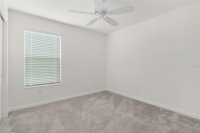 unfurnished room with ceiling fan and light colored carpet