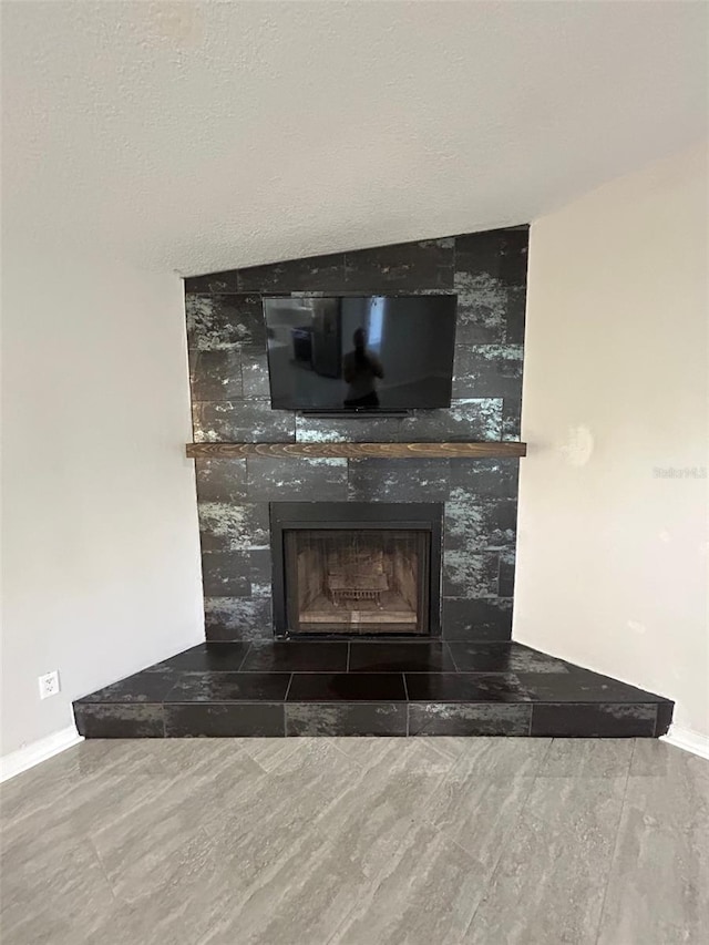 interior details with hardwood / wood-style flooring, a fireplace, and a textured ceiling