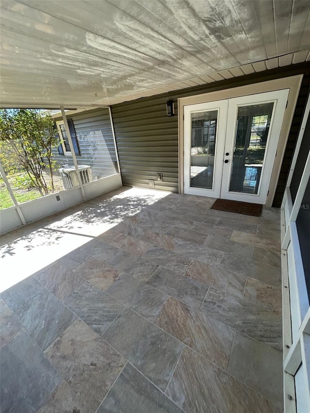 unfurnished sunroom with french doors