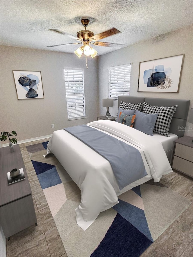 bedroom featuring ceiling fan and a textured ceiling