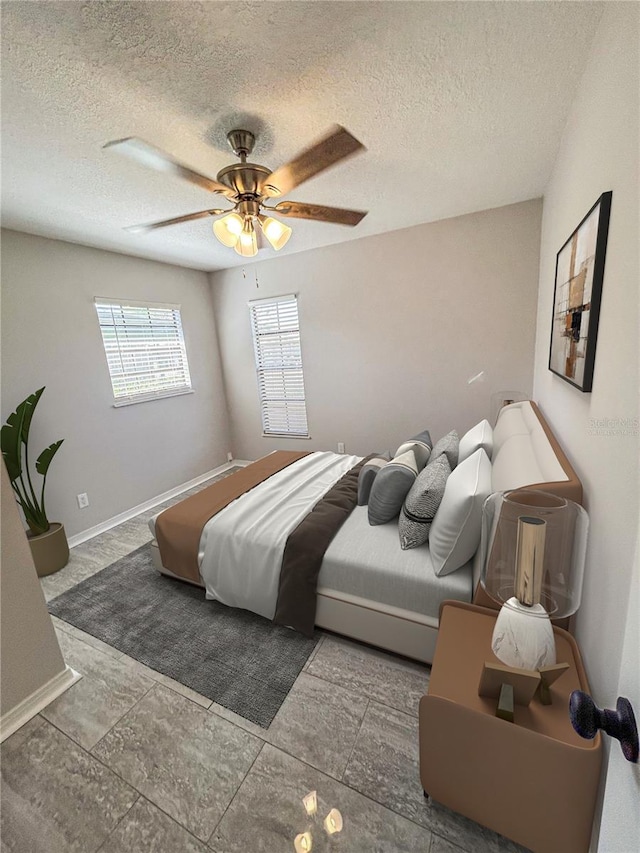 tiled bedroom featuring ceiling fan and a textured ceiling