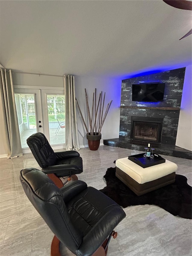 living area featuring baseboards and a premium fireplace