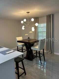 dining room with baseboards and a notable chandelier