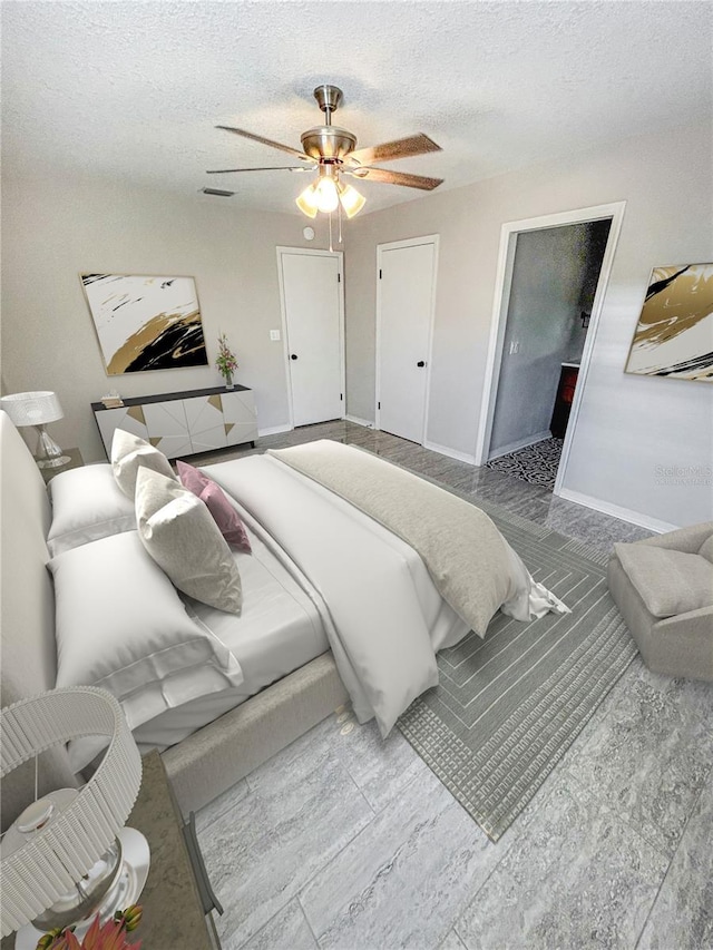 bedroom with a textured ceiling, baseboards, ceiling fan, and visible vents