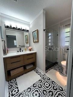full bathroom with a shower stall, toilet, vanity, ornamental molding, and baseboards