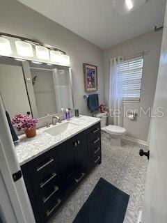 full bathroom with lofted ceiling, vanity, toilet, and baseboards