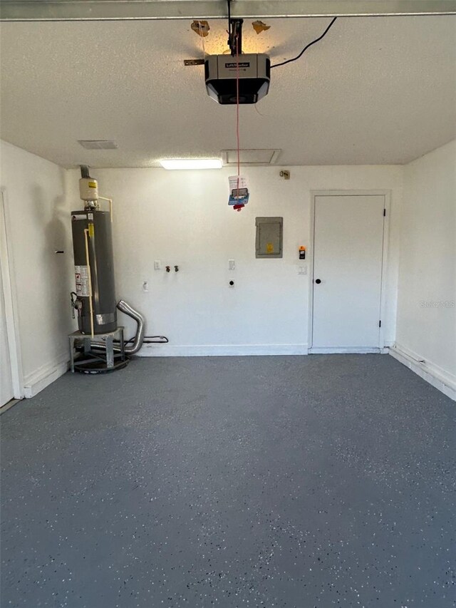 garage featuring a garage door opener, gas water heater, electric panel, and baseboards