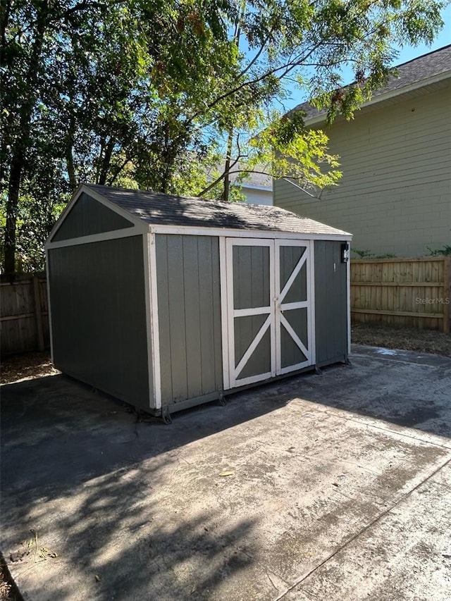 view of shed with a fenced backyard