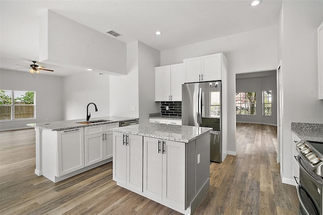 kitchen featuring a center island, white cabinets, and appliances with stainless steel finishes