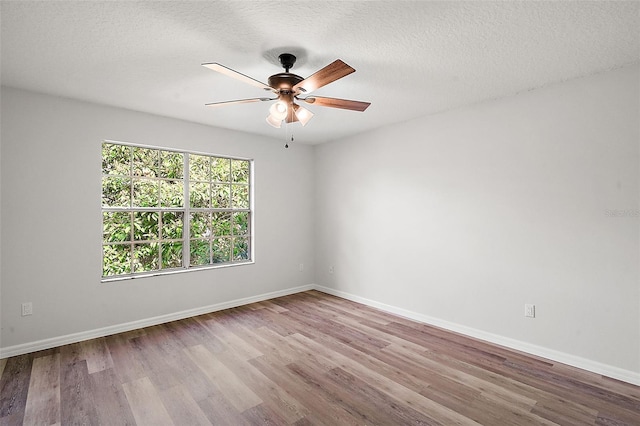 unfurnished room with ceiling fan, light hardwood / wood-style floors, and a textured ceiling