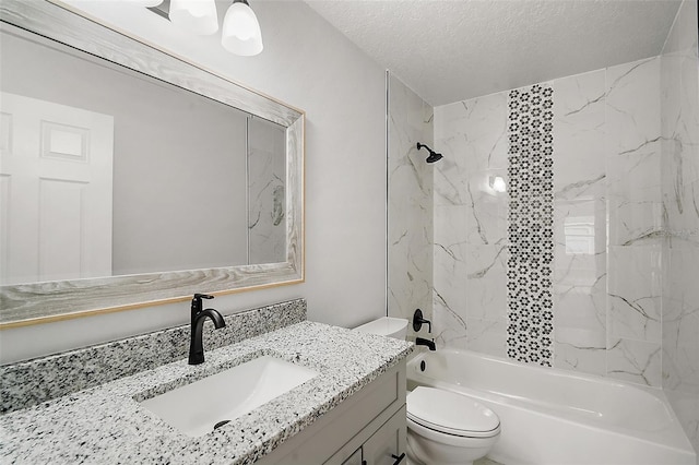 full bathroom with tiled shower / bath combo, toilet, a textured ceiling, and vanity