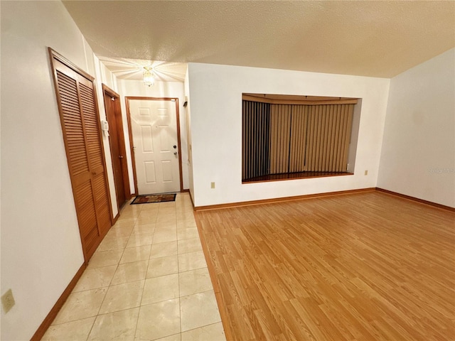 interior space with light hardwood / wood-style floors and a textured ceiling