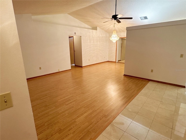 spare room featuring ceiling fan, light hardwood / wood-style flooring, and vaulted ceiling