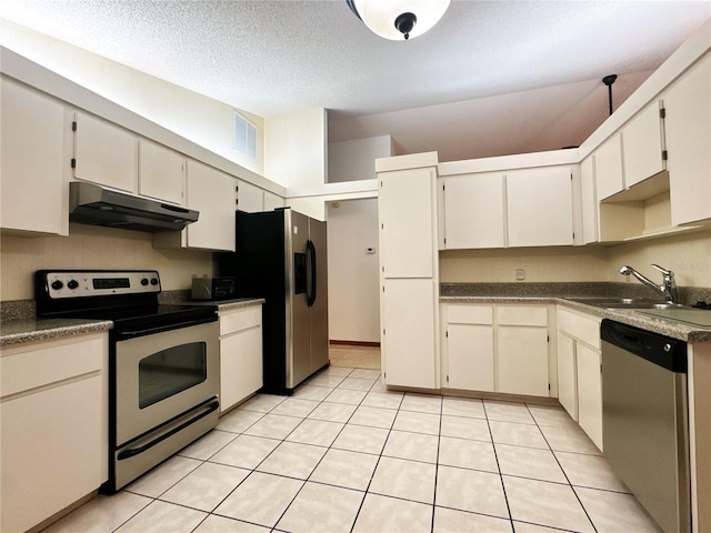 kitchen featuring light tile patterned floors, a textured ceiling, stainless steel appliances, and sink