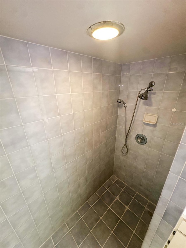 bathroom with tiled shower