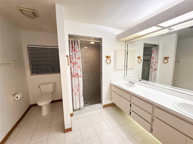 bathroom with tile patterned flooring, vanity, curtained shower, and toilet