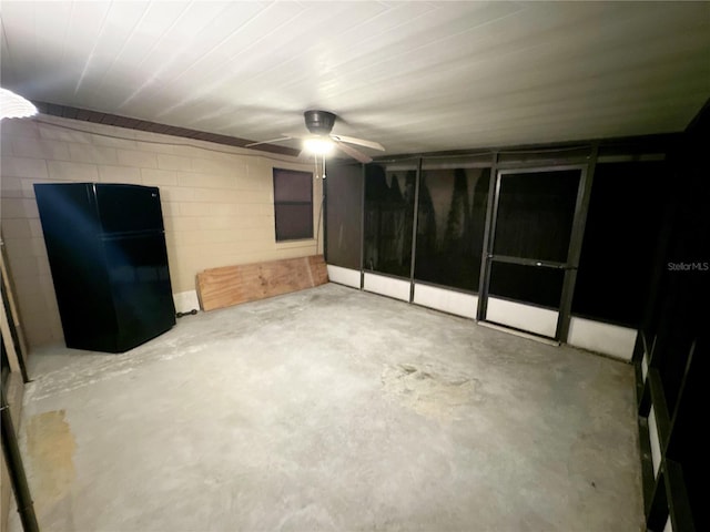 spare room with ceiling fan and concrete flooring