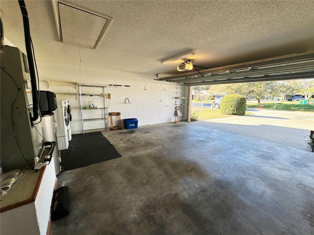 garage with washer and clothes dryer and a garage door opener