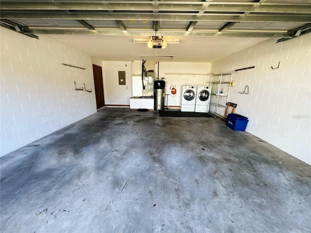 garage with independent washer and dryer, electric panel, a garage door opener, and hybrid water heater