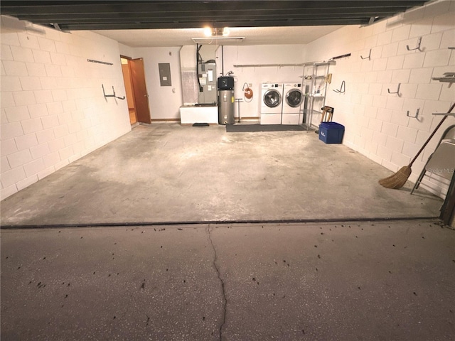 garage with electric panel and washer and dryer