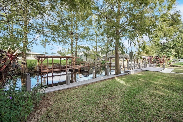 dock area featuring a lawn and a water view