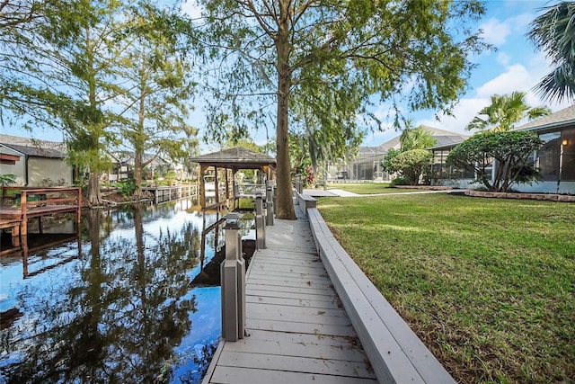 view of dock featuring a yard and a water view