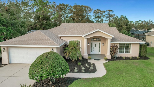 single story home featuring a front lawn and a garage