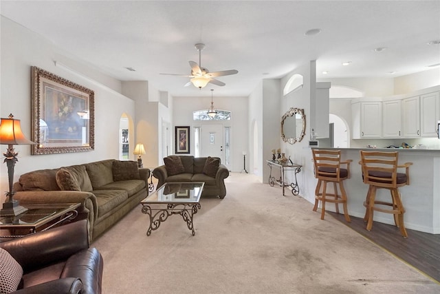 living room with ceiling fan and light wood-type flooring