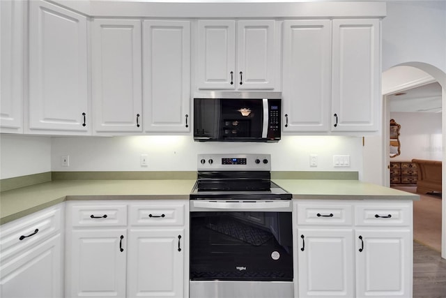 kitchen featuring white cabinets, hardwood / wood-style floors, and appliances with stainless steel finishes