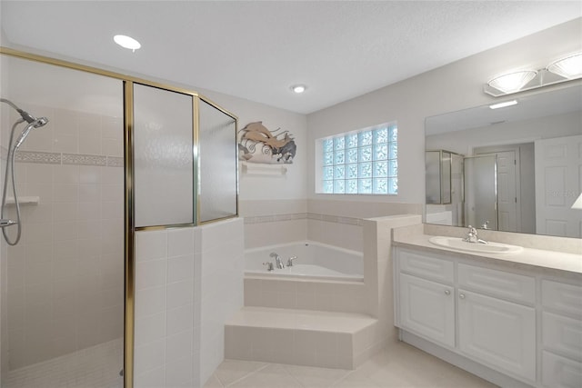 bathroom featuring tile patterned floors, vanity, a textured ceiling, and independent shower and bath