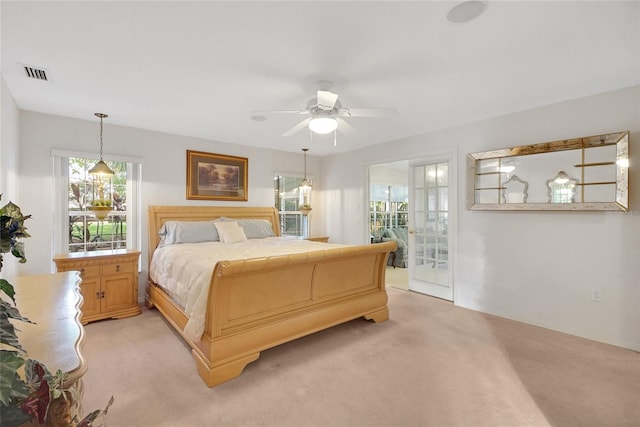 carpeted bedroom with ceiling fan and access to outside