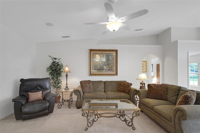 living room with carpet flooring, ceiling fan, and lofted ceiling