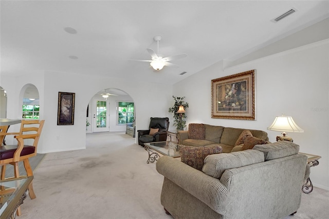 living room featuring ceiling fan, plenty of natural light, light colored carpet, and lofted ceiling