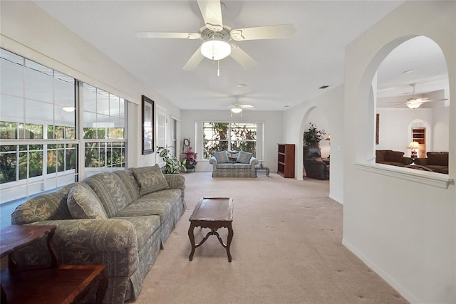 carpeted living room featuring ceiling fan